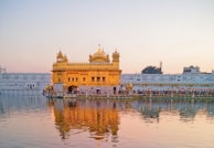 A golden sunset reflecting off the ocean waves beside the temple.