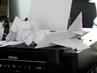 a bunch of papers sitting on top of a printer