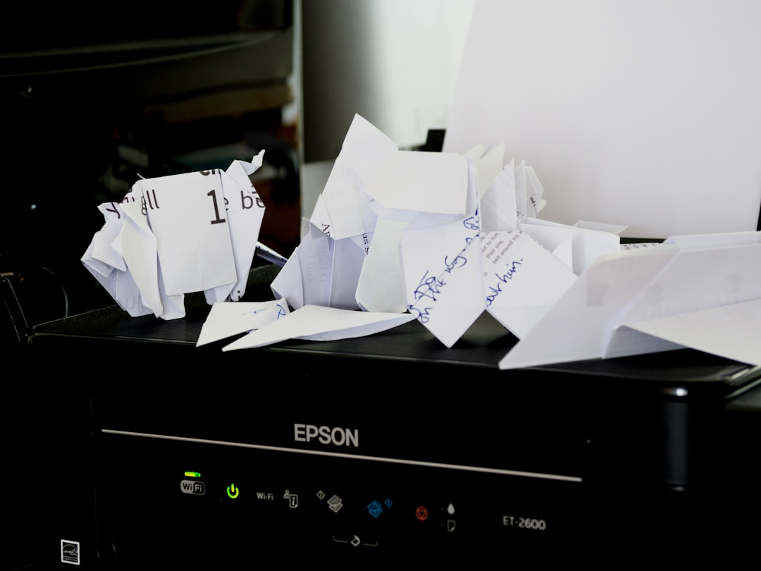A printer with a stack of paper on top, symbolizing enhanced security and compliance with cloud fax services.