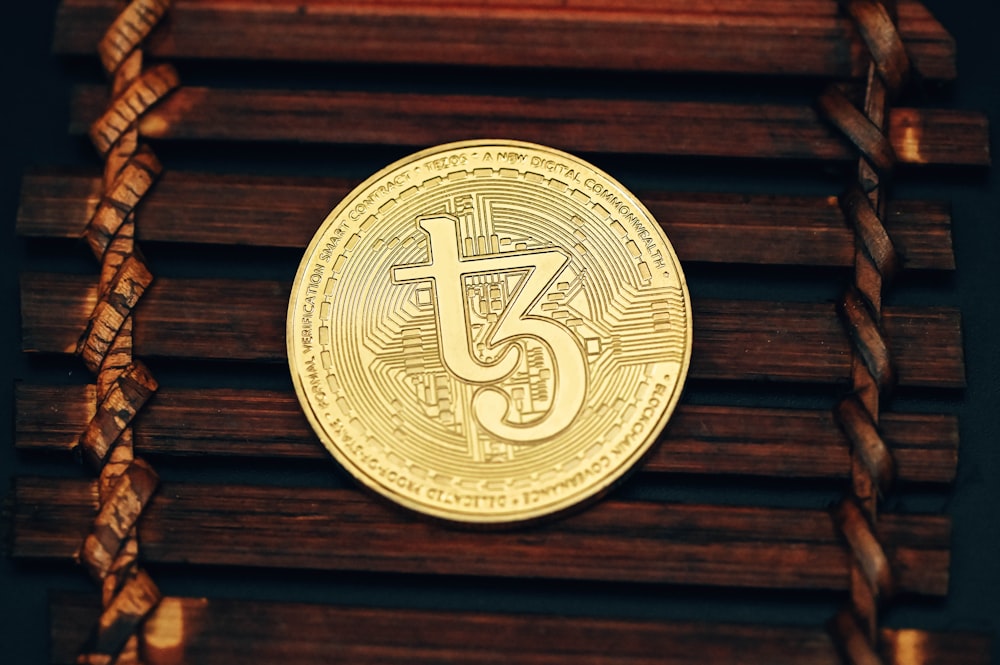 a gold coin sitting on top of a wooden box