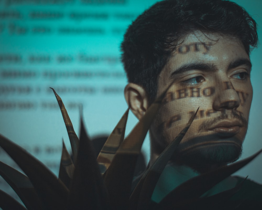 a man with his face painted with words
