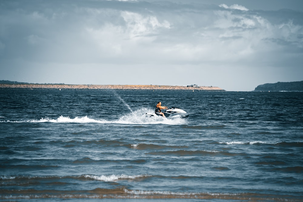 a man riding a jet ski on top of a body of water