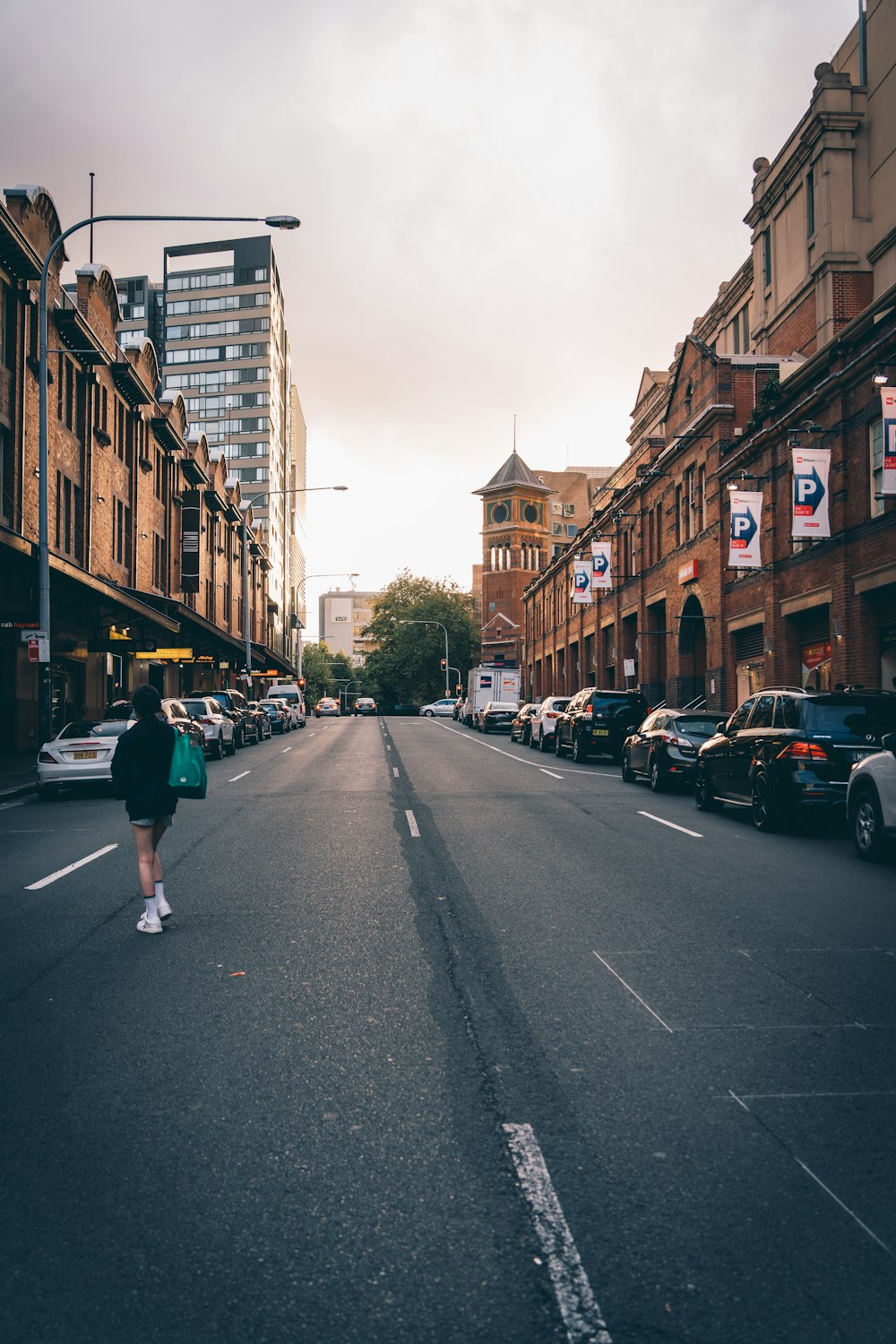 a person walking down the middle of a street