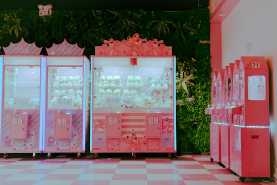 a row of pink vending machines sitting next to each other
