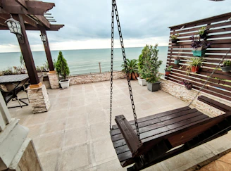 Cozy patio with terravela waterproof curtains gently swaying in the breeze under a sunny sky