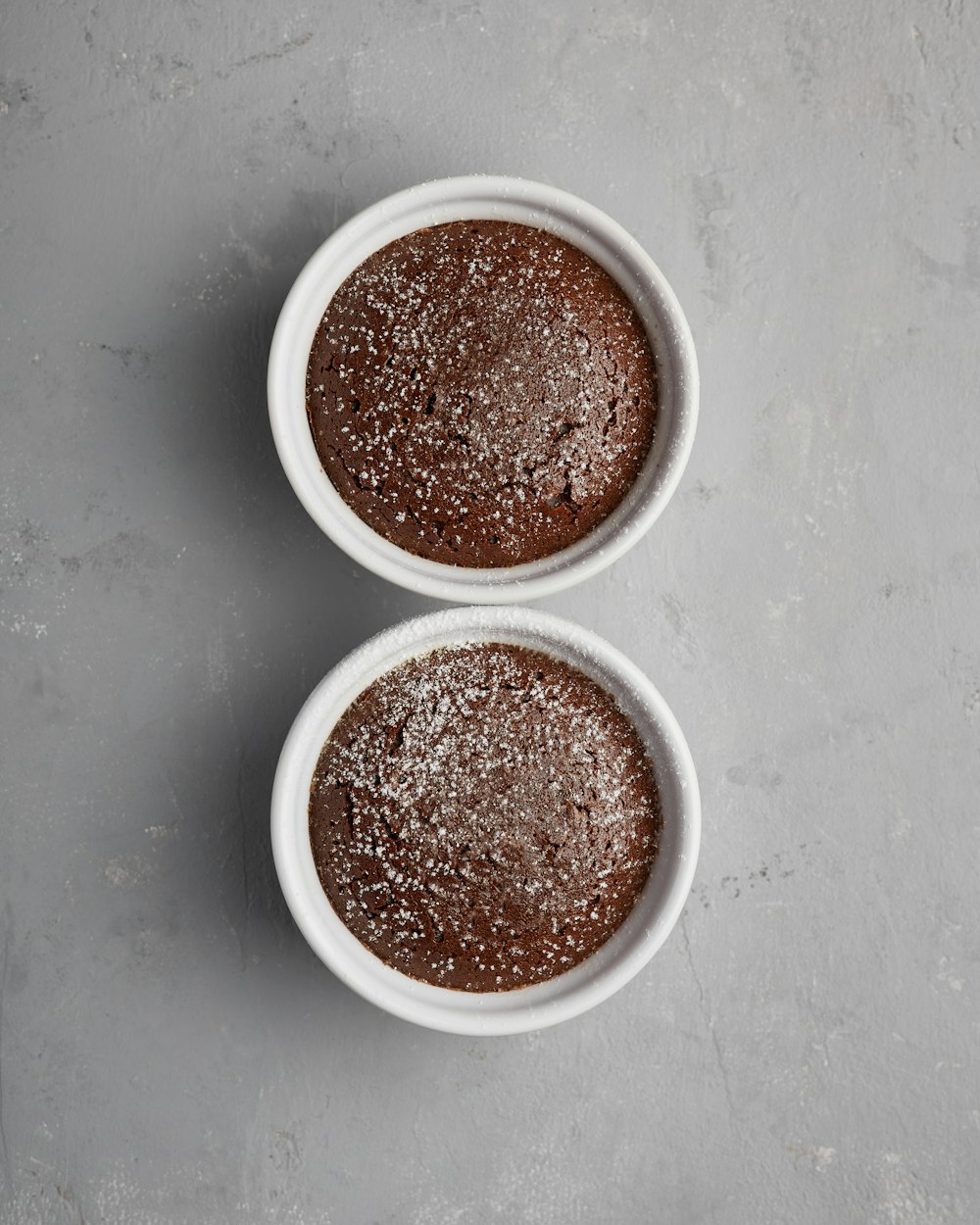 two bowls of chocolate cake on a table