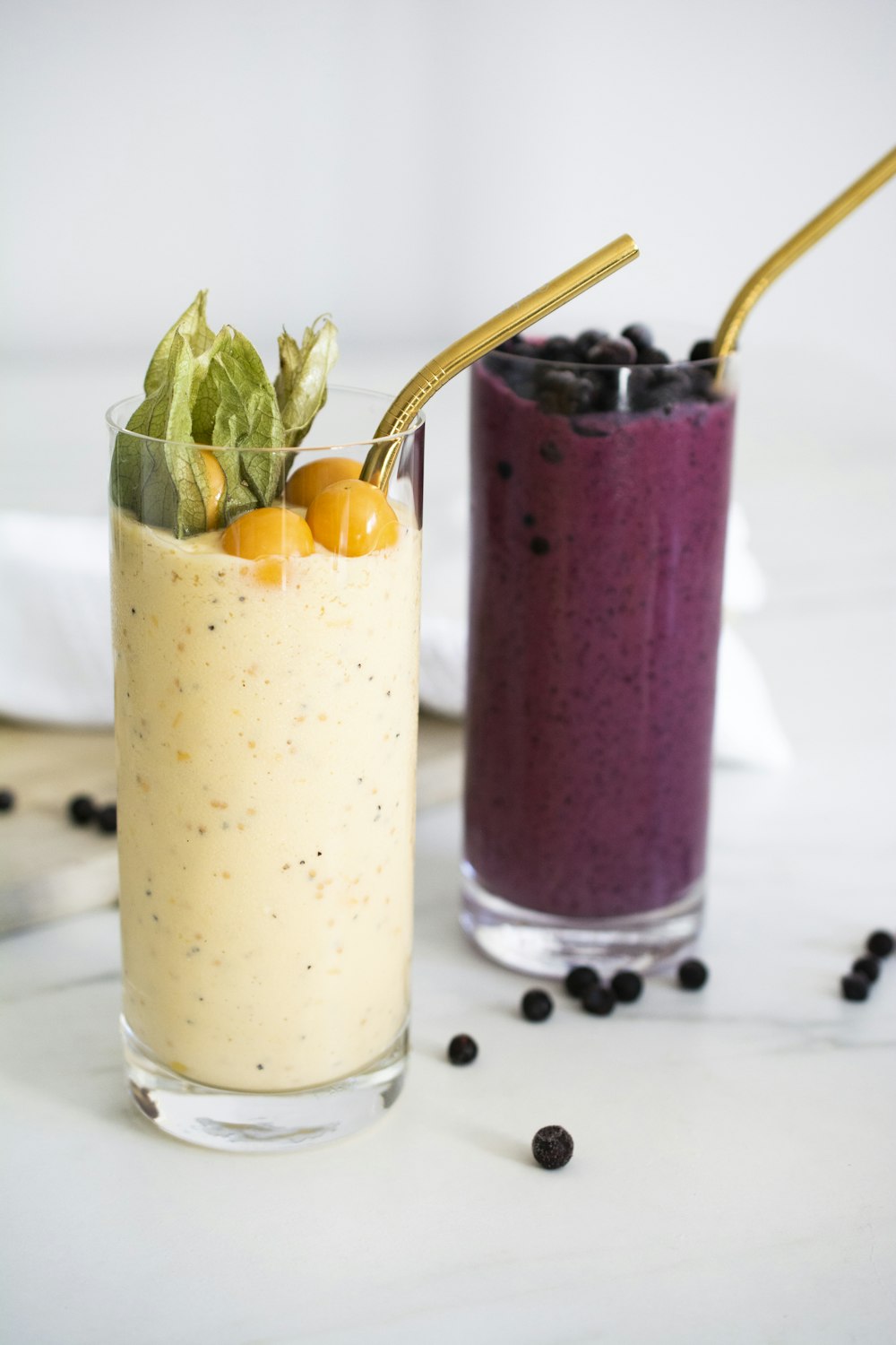 two glasses filled with different types of smoothies