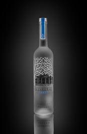 a bottle of belvedere vodka on a black background