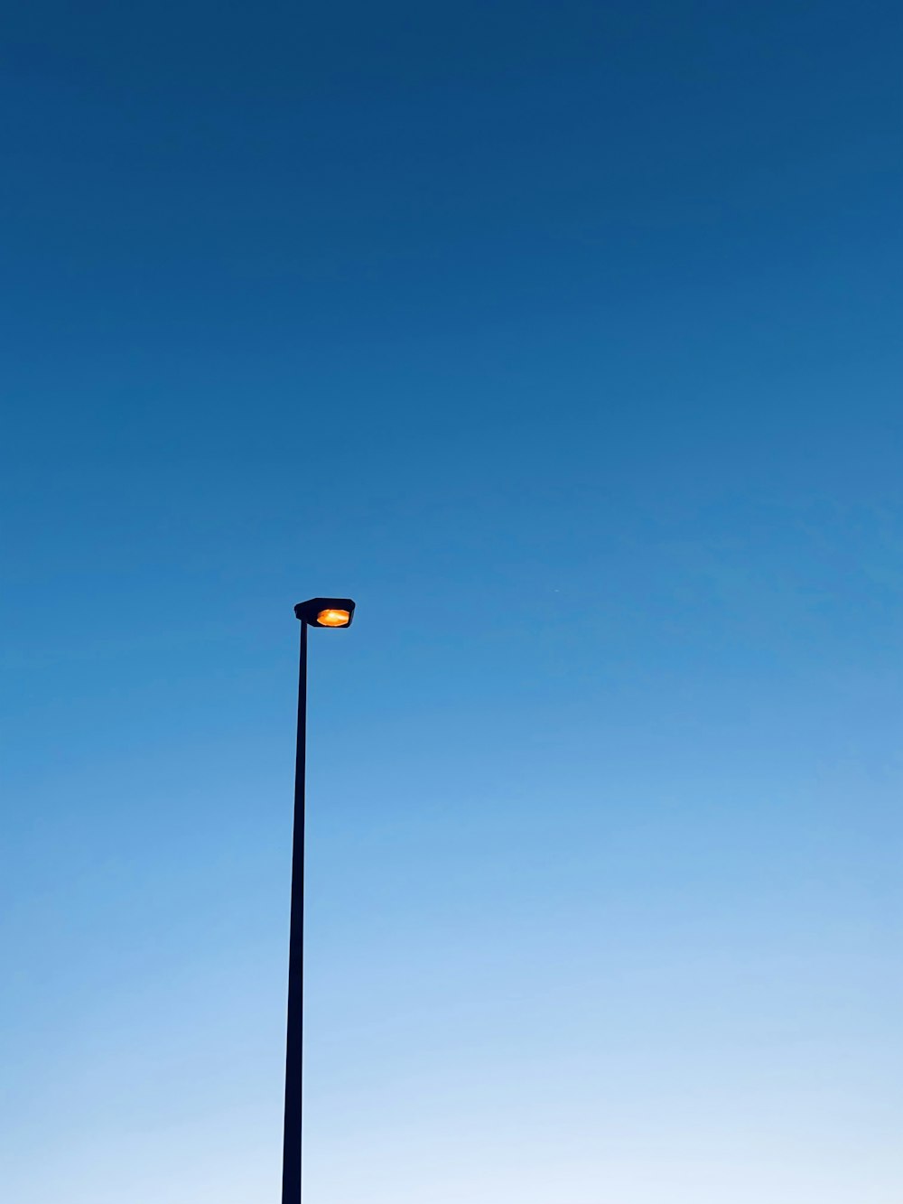 a street light with a blue sky in the background