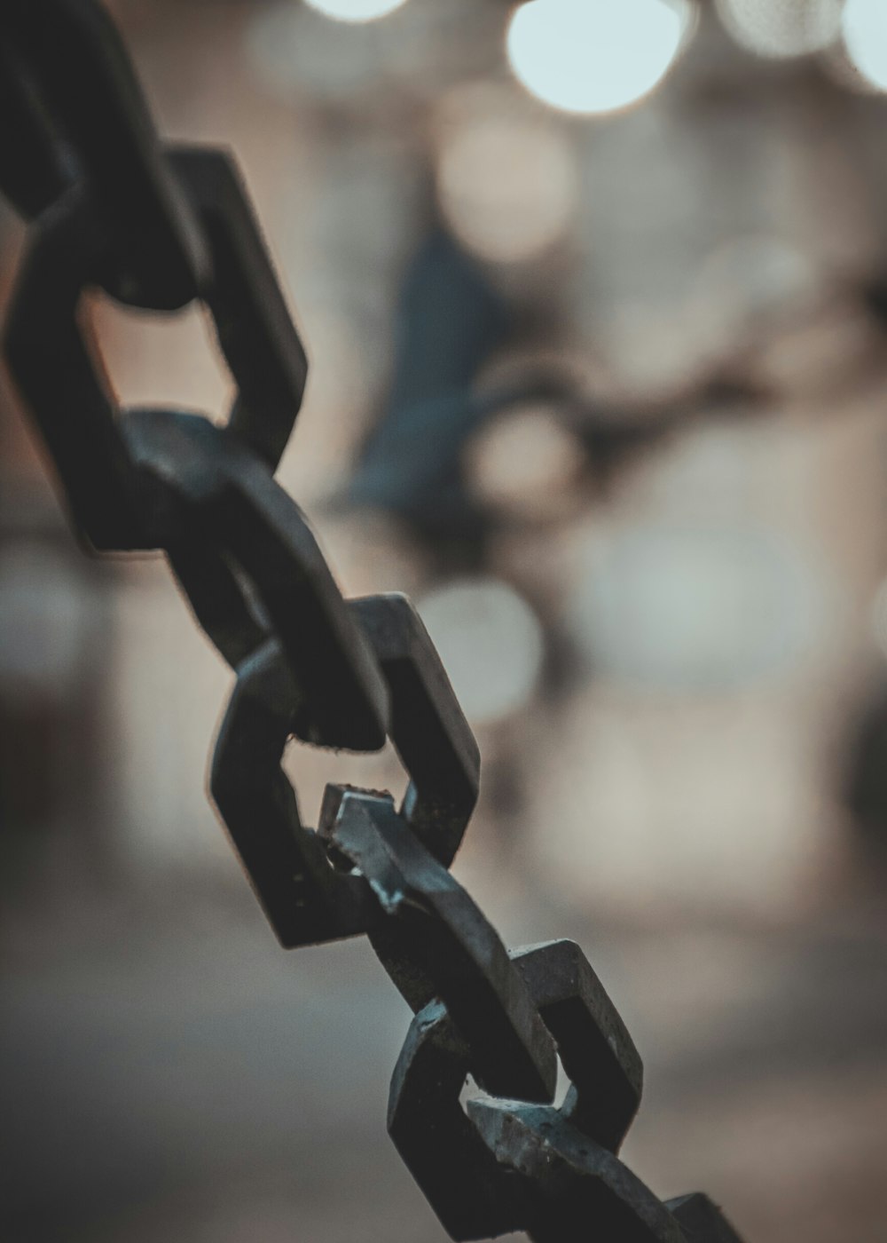 a close up of a chain with a blurry background