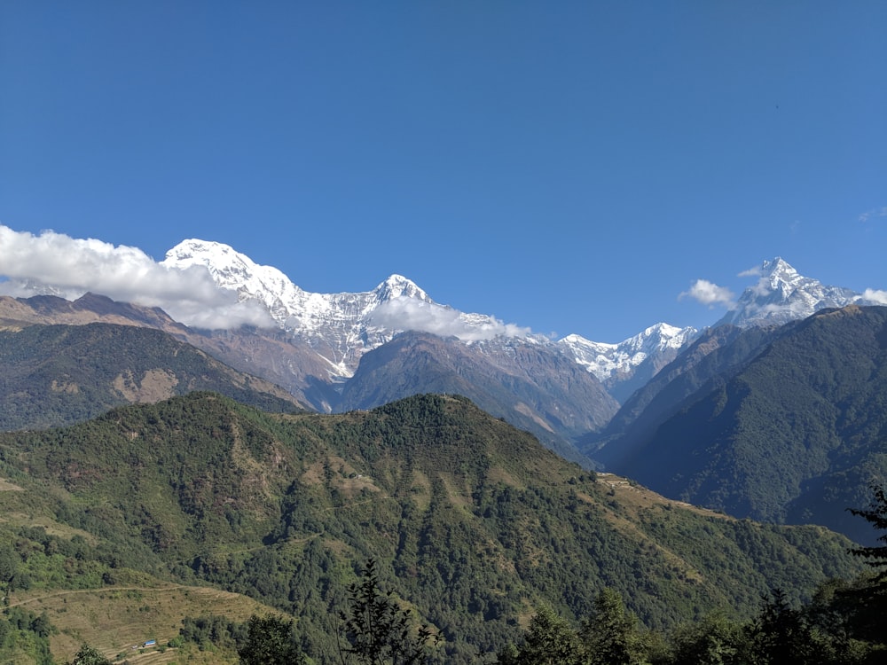 a mountain range with snow capped mountains in the distance