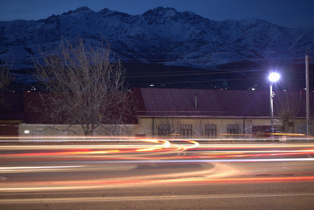 a blurry photo of a street with a building and mountains in the background
