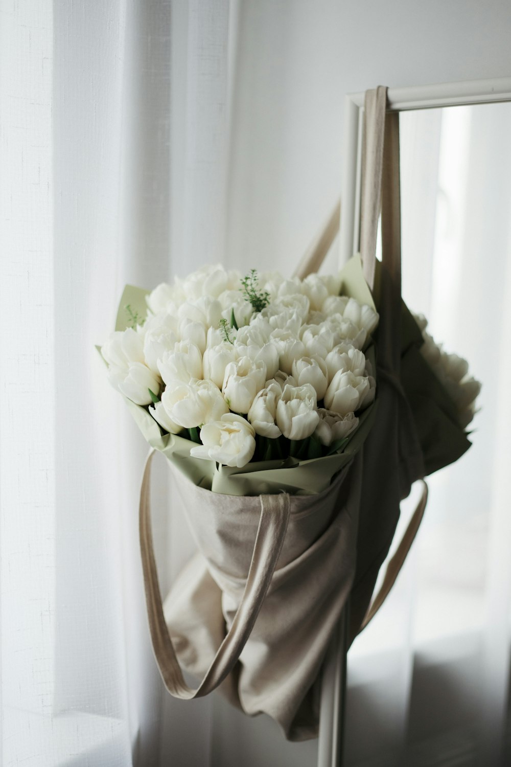 a bouquet of white flowers sitting on top of a chair