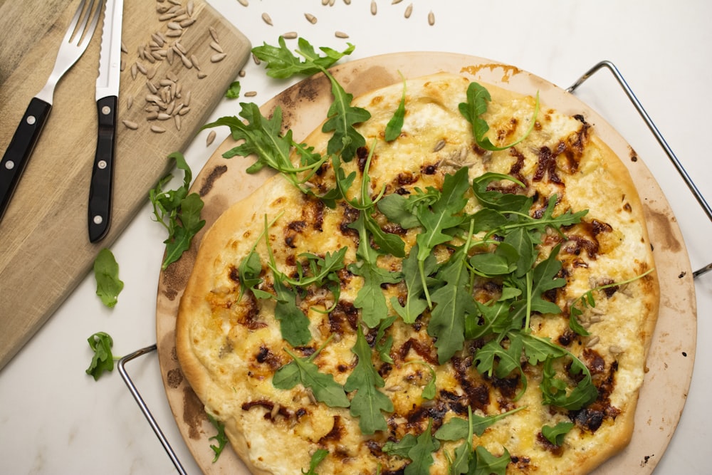 a pizza sitting on top of a wooden cutting board