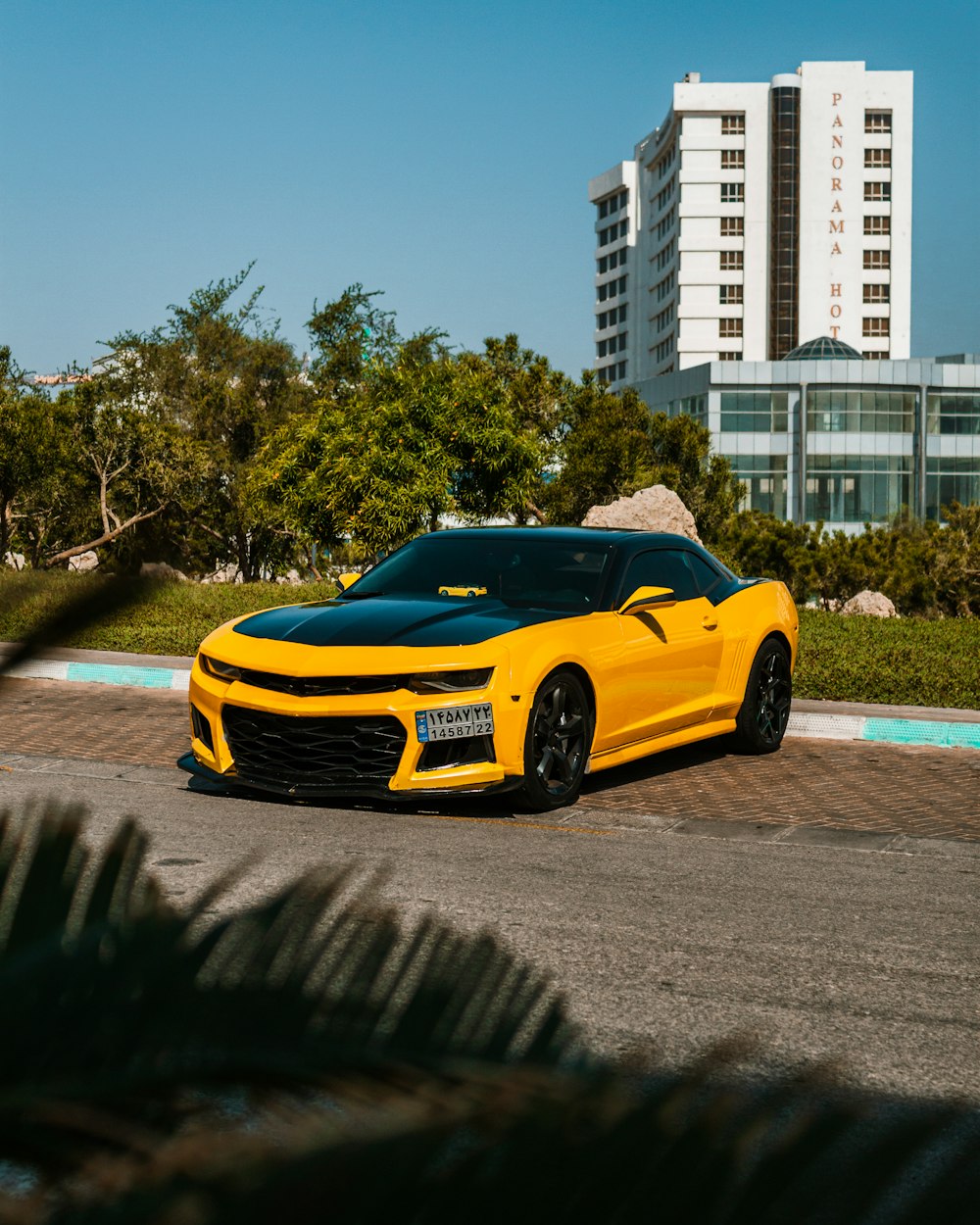 a yellow sports car parked in a parking lot