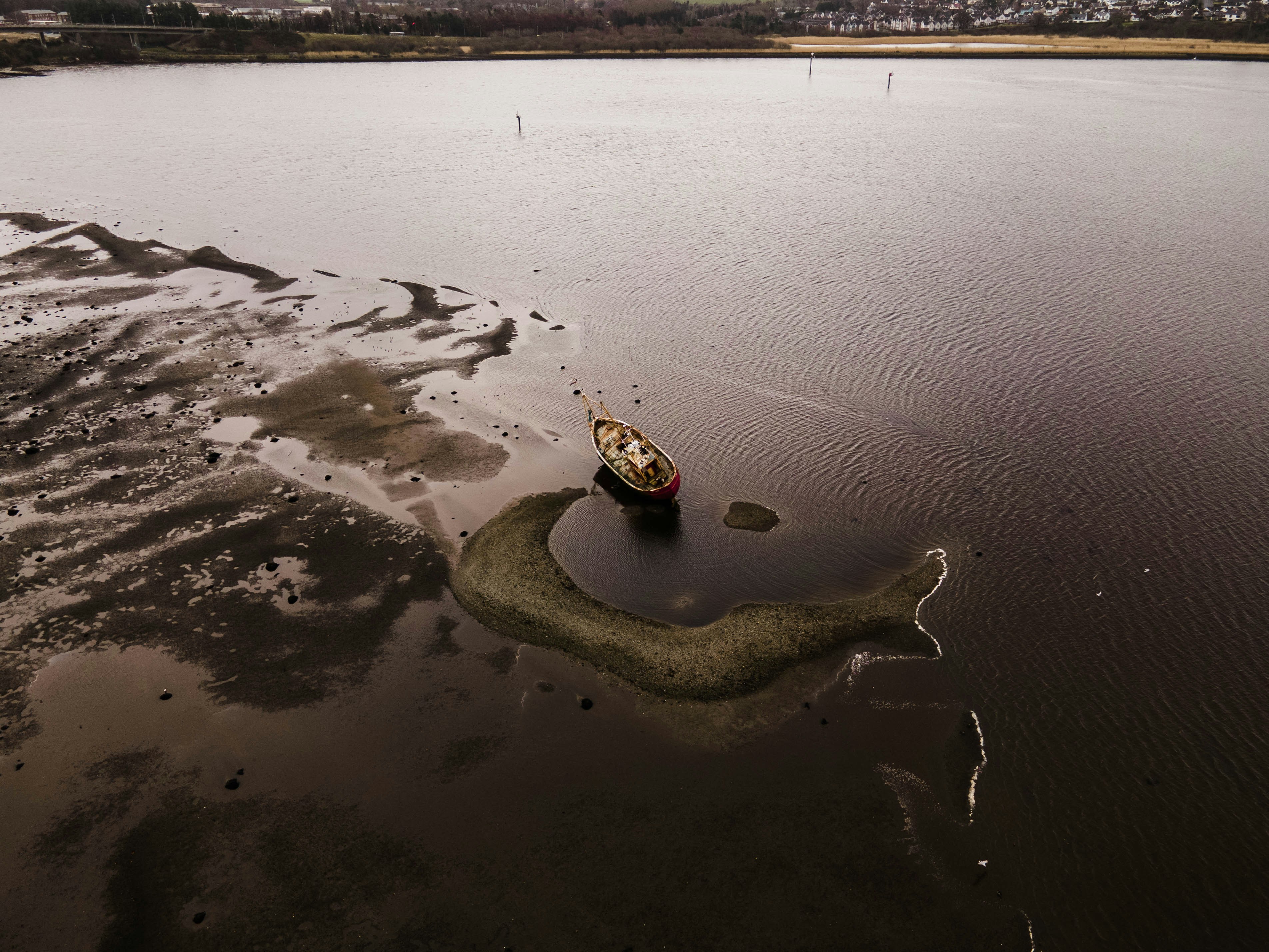 a small boat floating on top of a large body of water