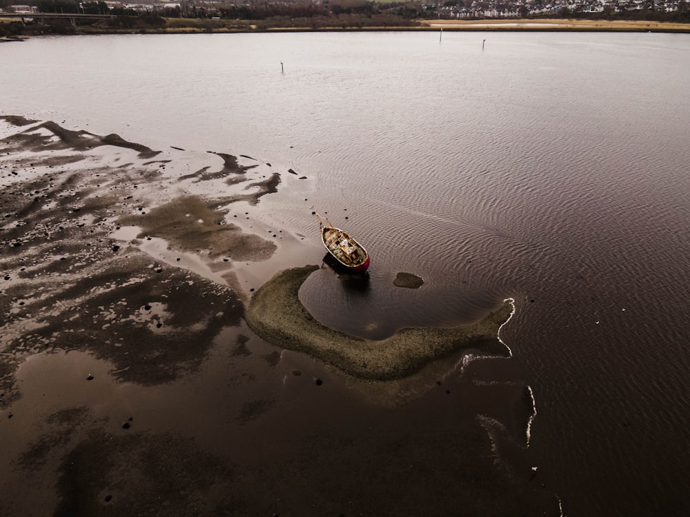 a small boat floating on top of a large body of water