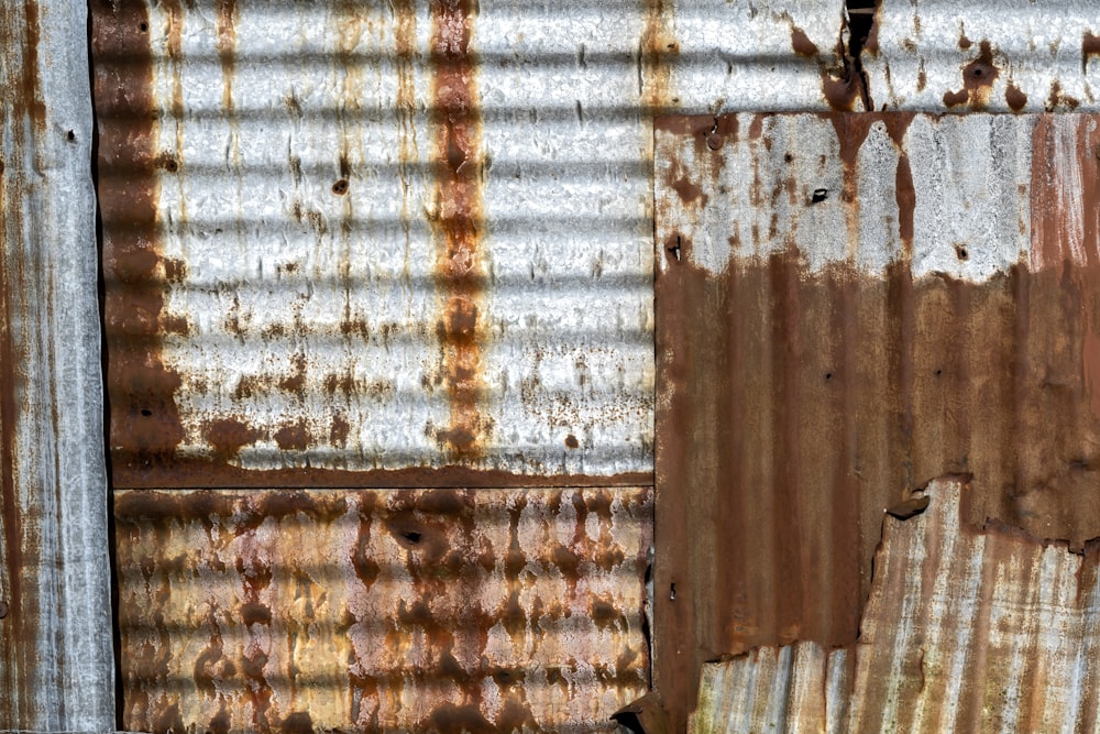 a rusted metal wall with peeling paint