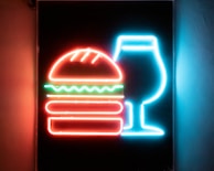 Colorful burger menu boards displayed on a bright wall.