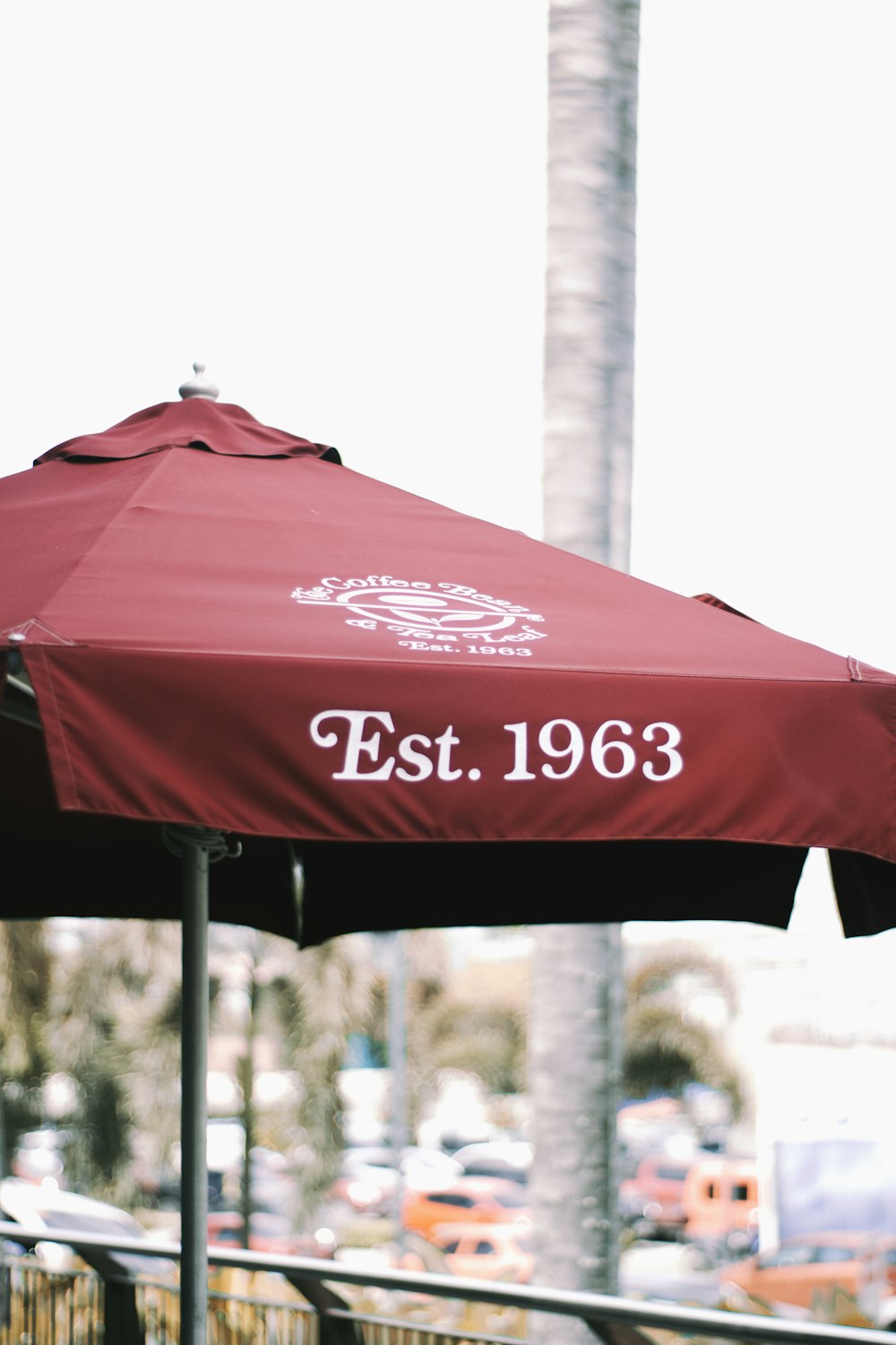 a red umbrella sitting on top of a wooden table