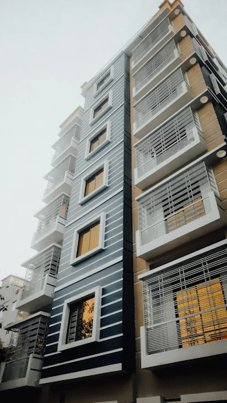Modern European residential community with sleek architecture and blue, white, and gold accents.