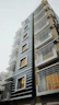Modern residential building with clean lines and blue accents.