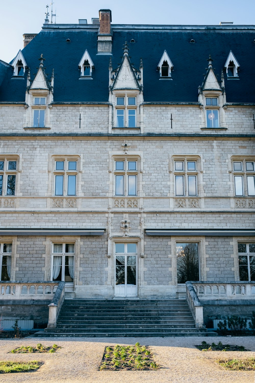 a large stone building with a blue roof