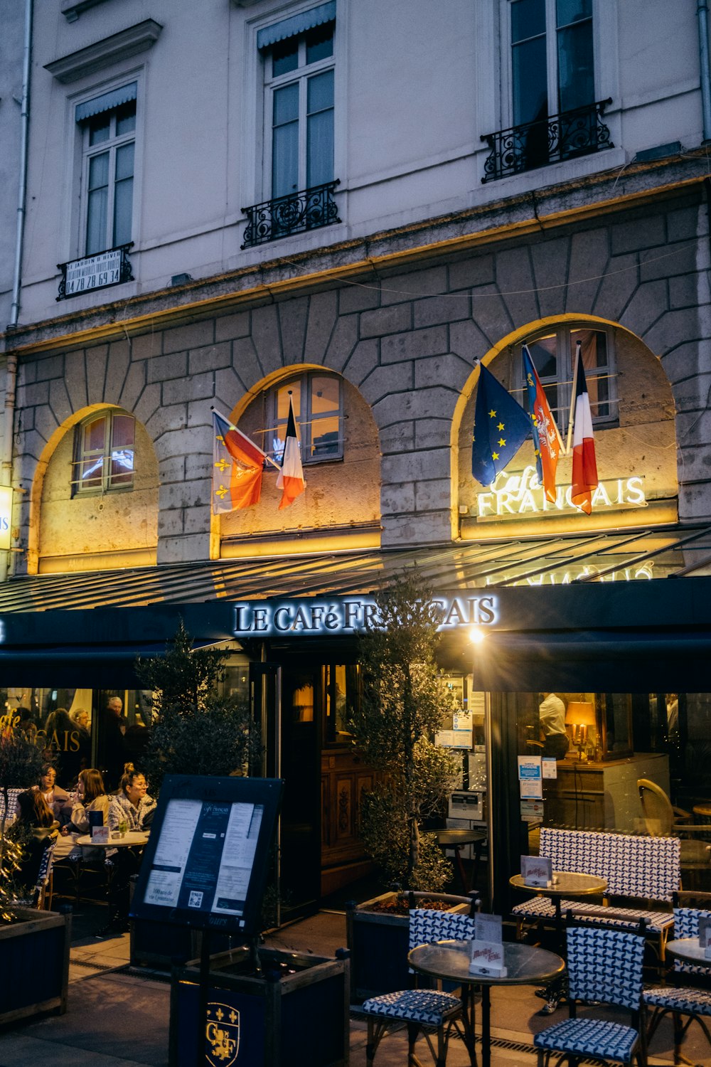 a restaurant with tables and chairs outside of it