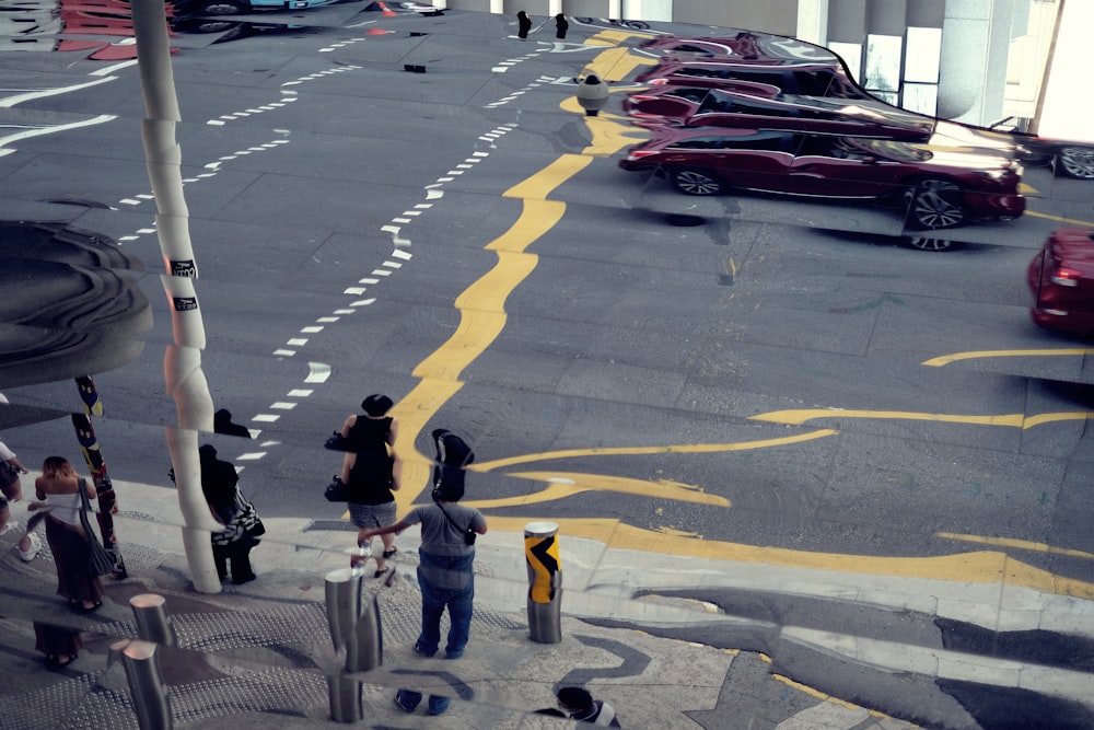 a group of people standing on the side of a road