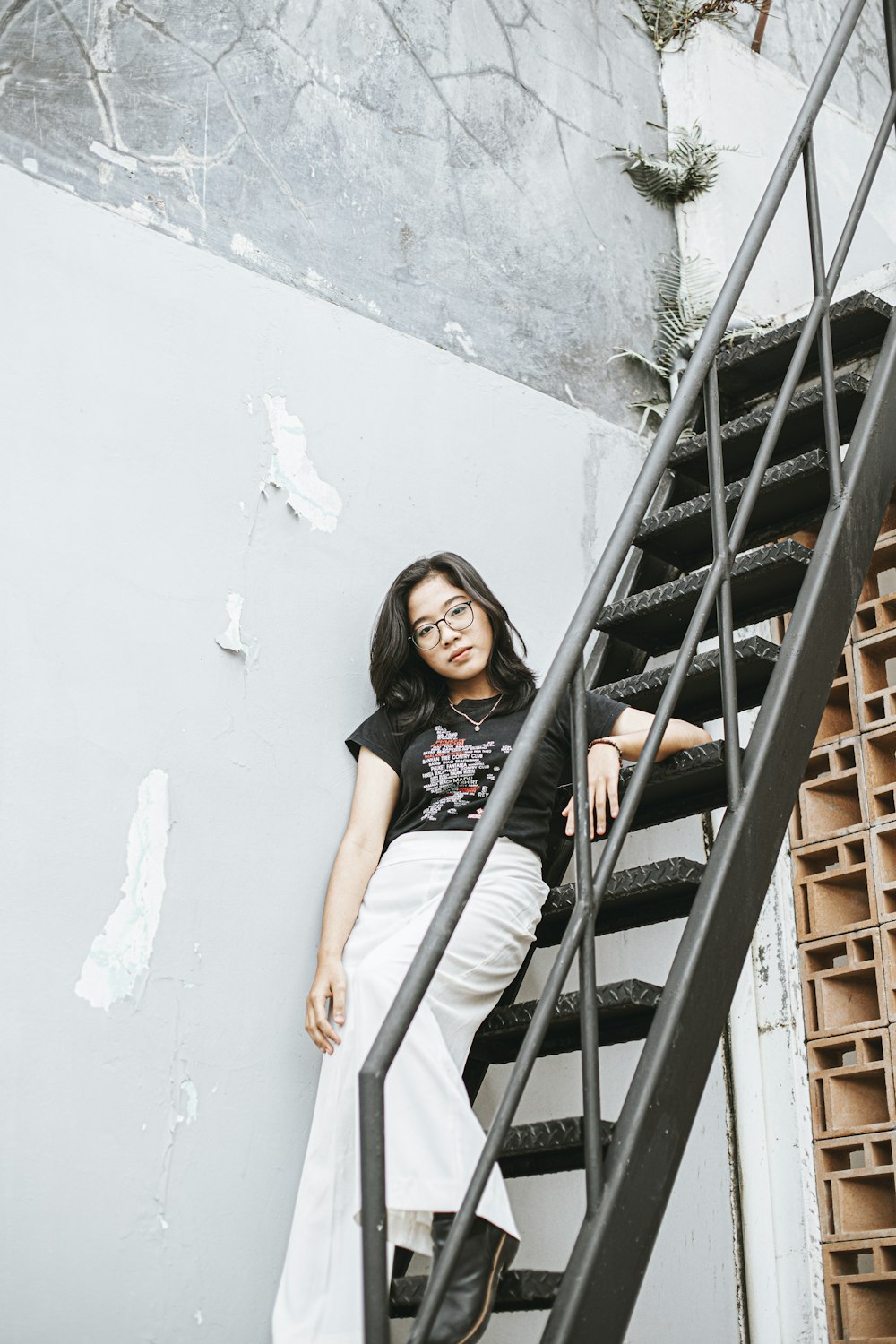 a woman sitting on top of a set of stairs