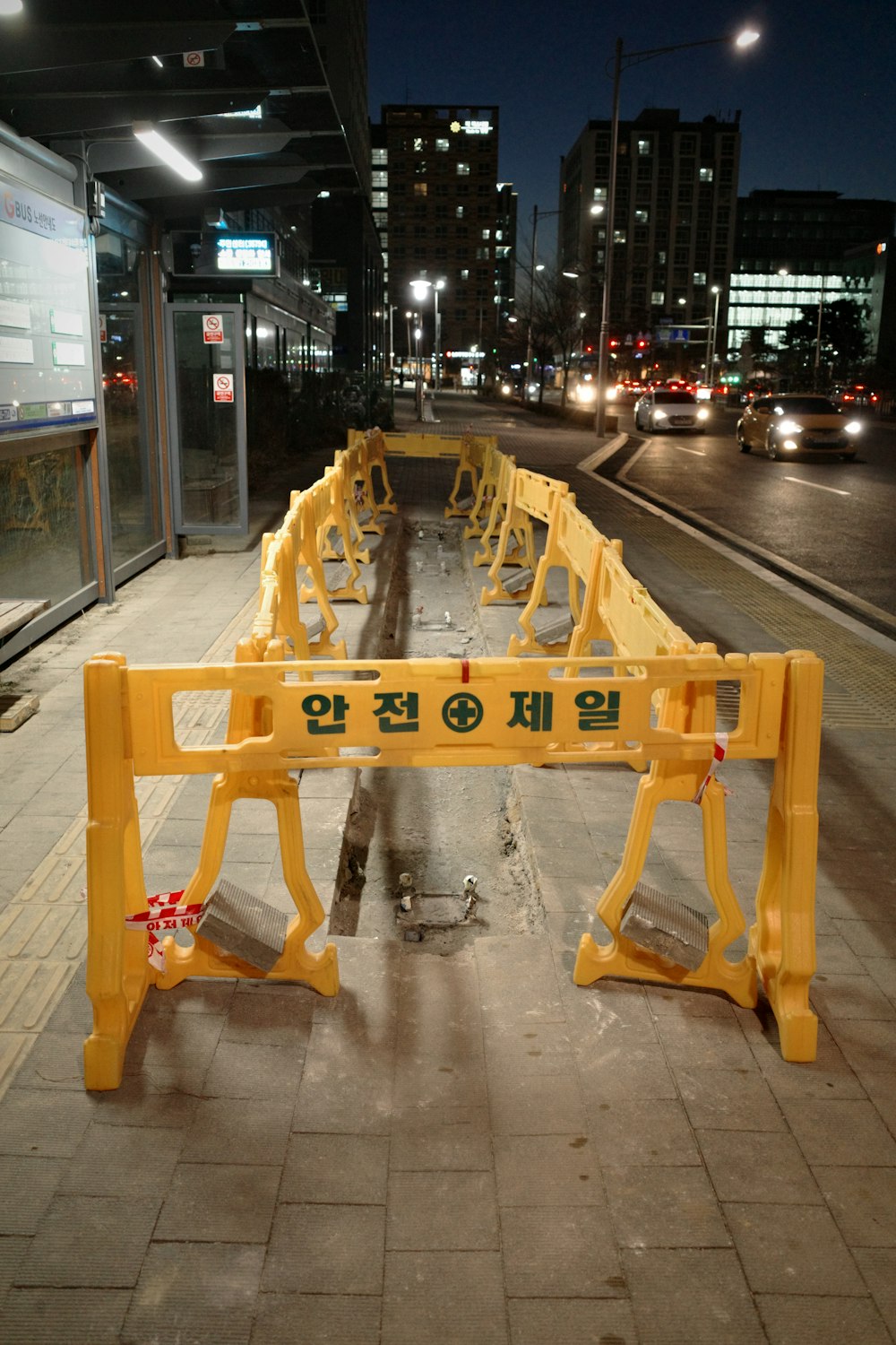 a yellow bench sitting on the side of a road