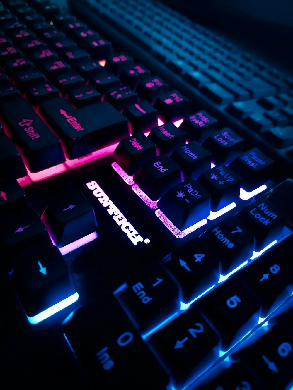 a close up of a computer keyboard with glowing keys