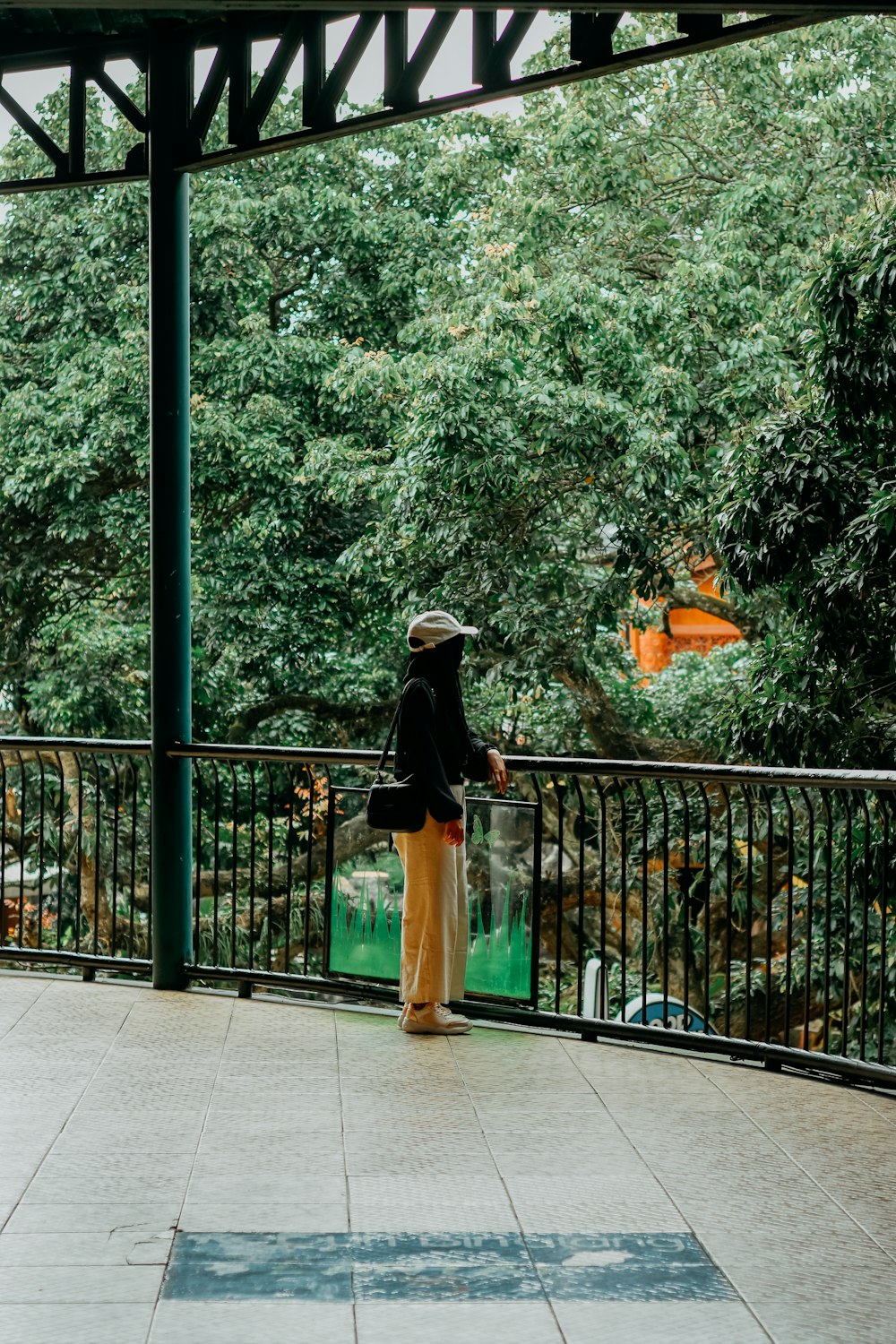 a person standing on a bridge with a bucket