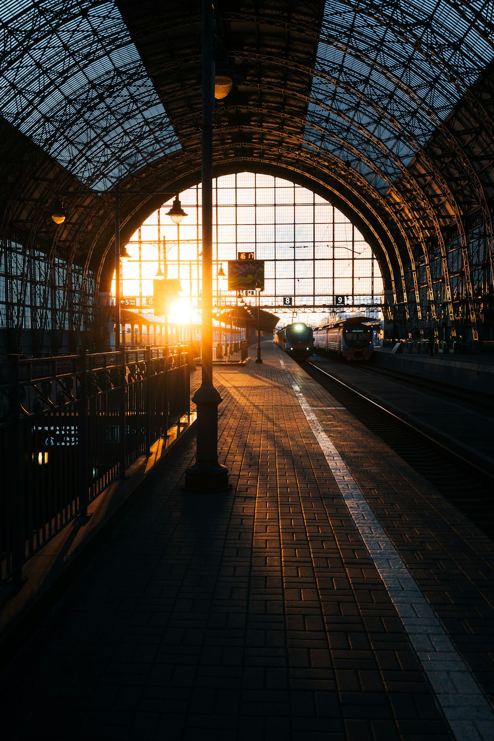 a train station with the sun shining through the windows