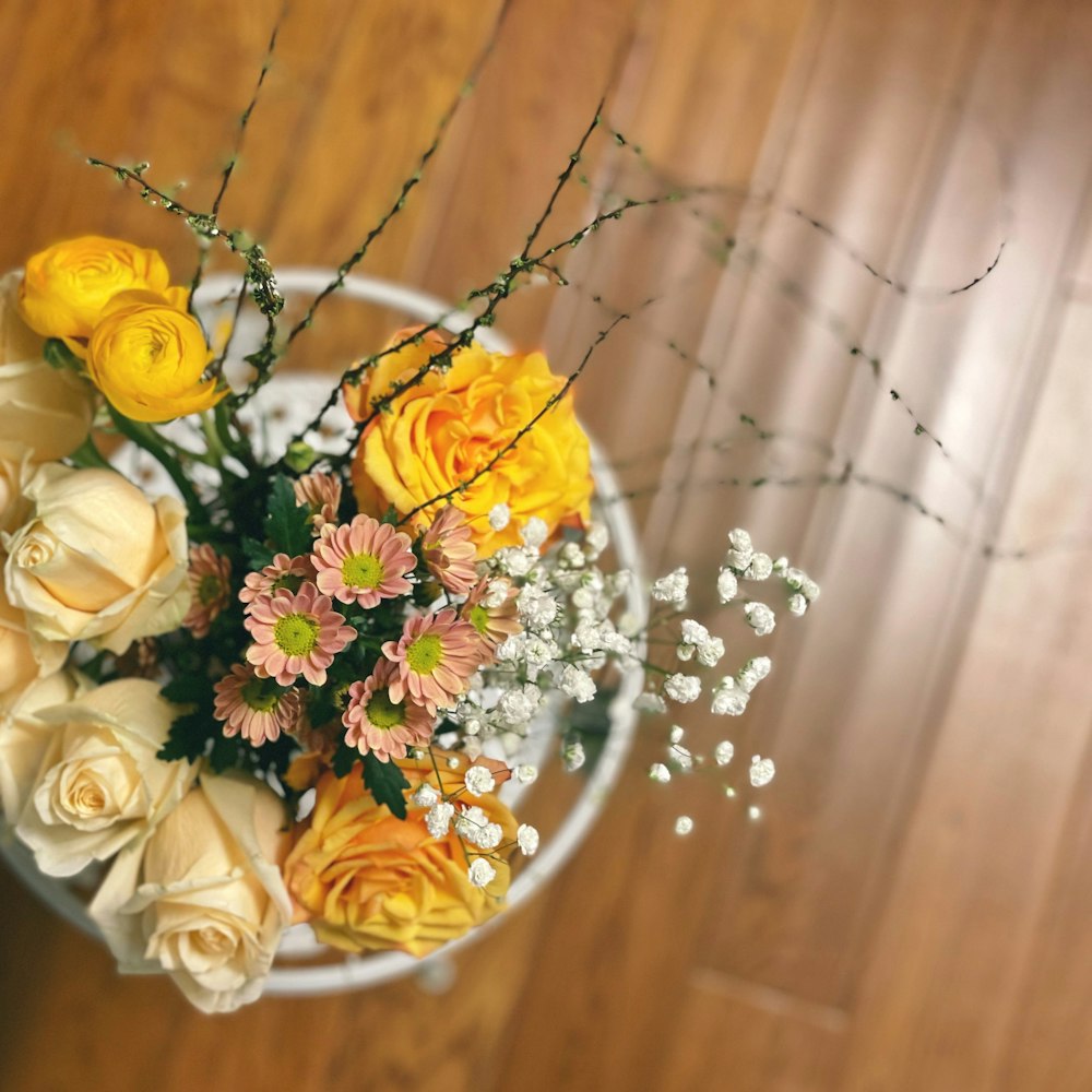 a vase filled with lots of different colored flowers