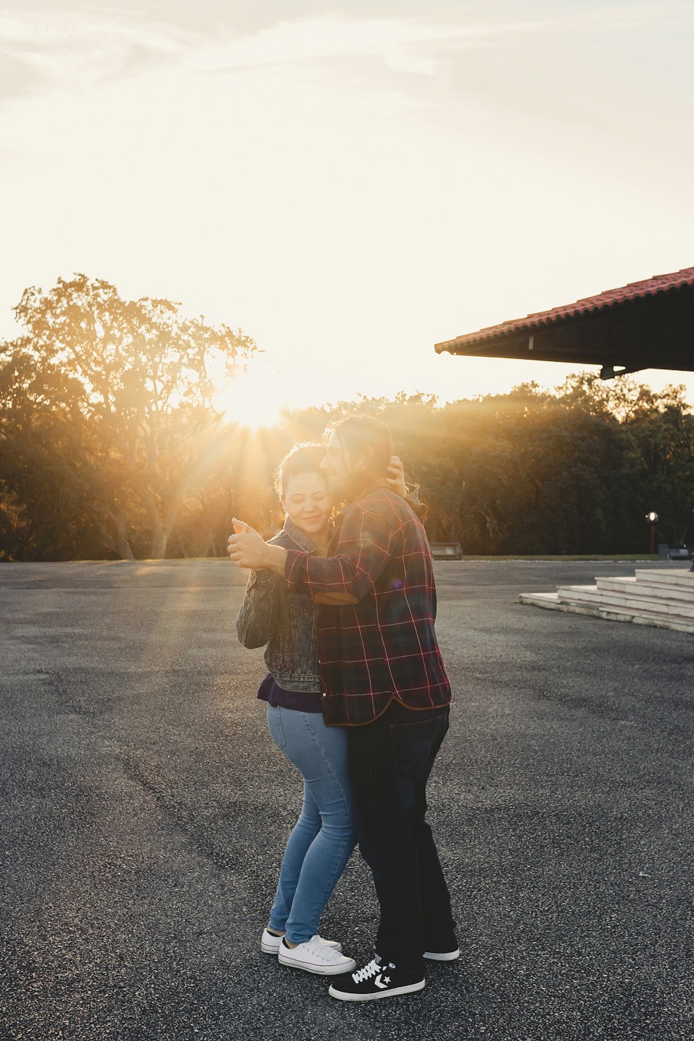 a man and woman standing in the middle of a parking lot