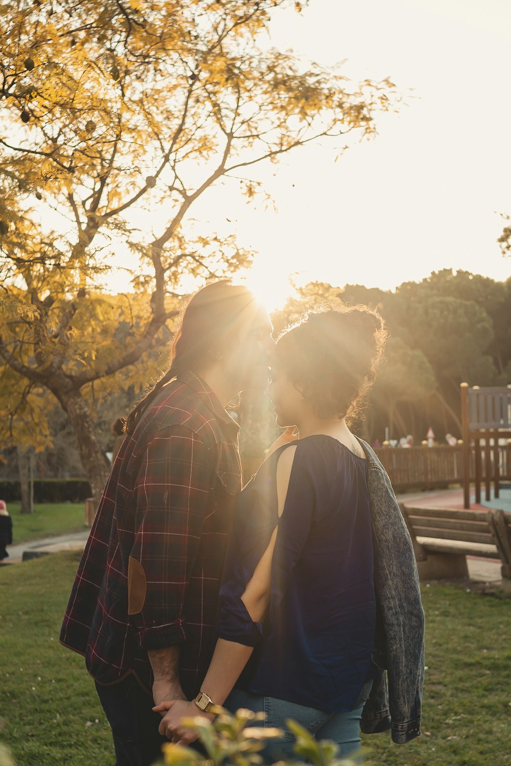 a couple of people that are standing in the grass