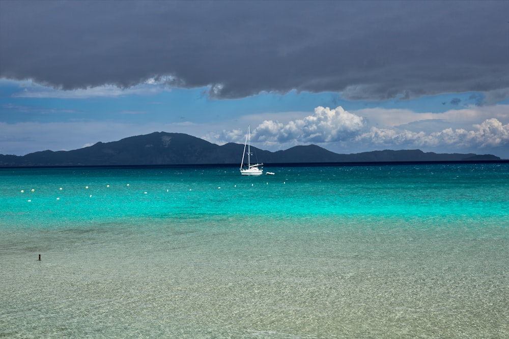 a sailboat floating on top of a body of water