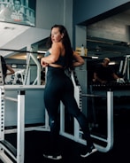 a woman standing on a machine in a gym
