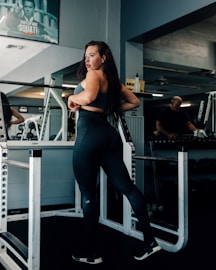 a woman standing on a machine in a gym