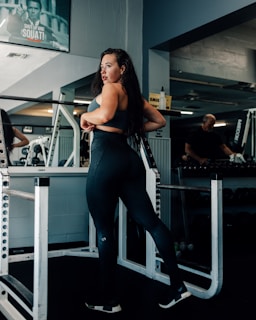 a woman standing on a machine in a gym