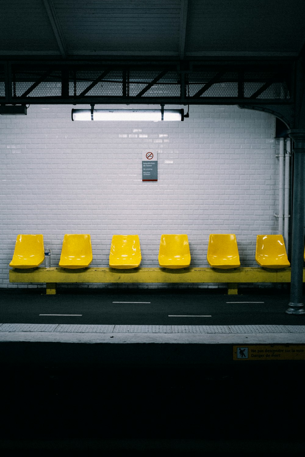 a row of yellow seats sitting next to each other
