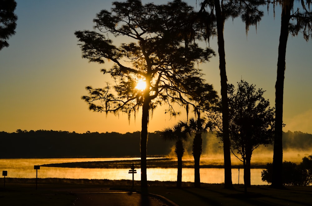 the sun is setting over a body of water