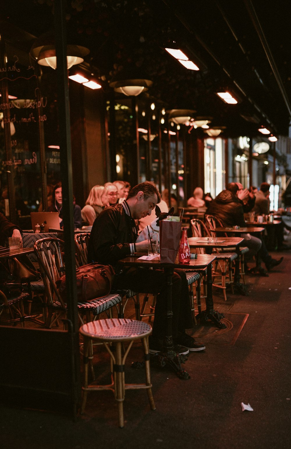 a group of people sitting at tables in a restaurant