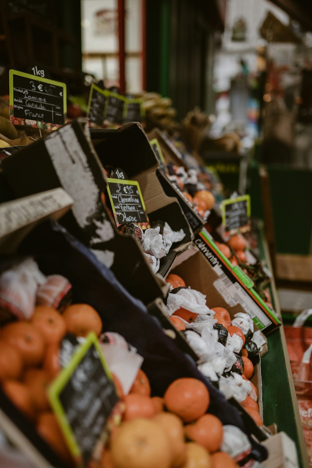 a produce section of a grocery store filled with oranges