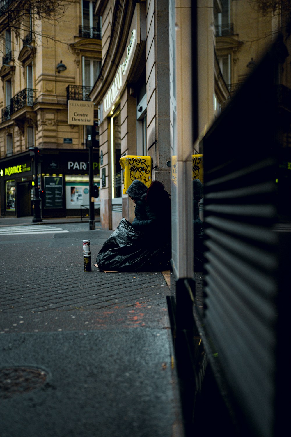 a person sitting on a bench on a city street