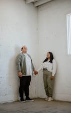 Real estate agent handing over house keys to satisfied clients in a bright room.