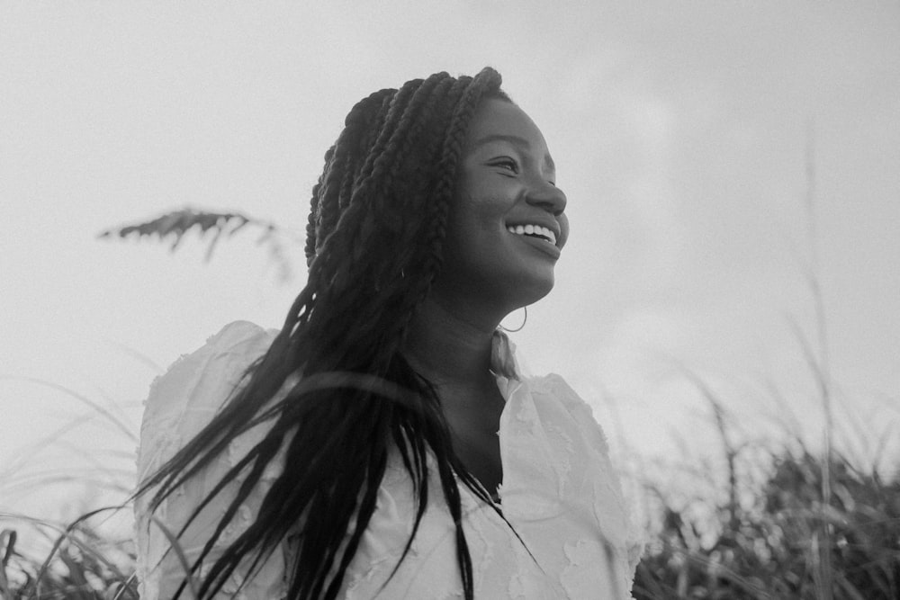 a black and white photo of a woman smiling