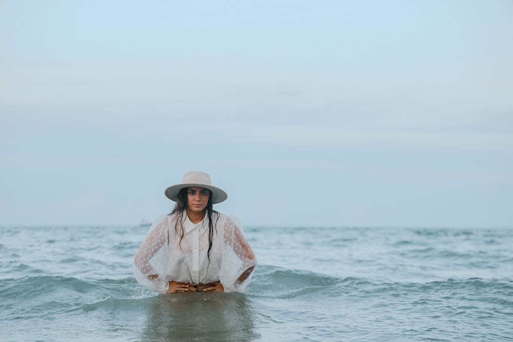 a woman sitting on top of a surfboard in the ocean