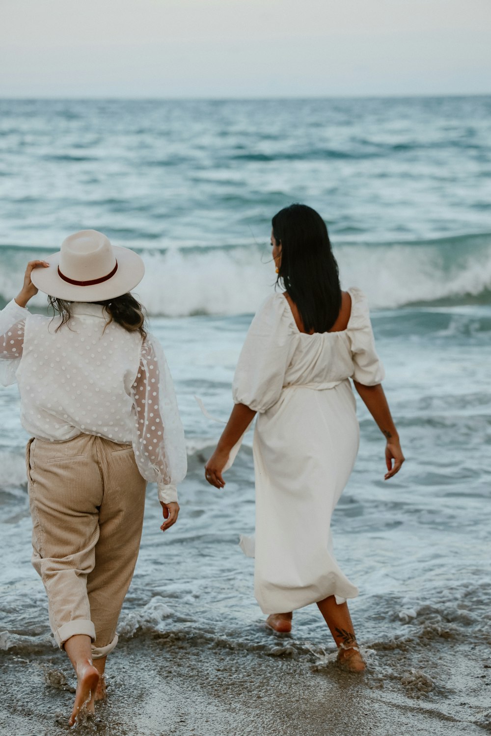 a couple of people that are walking in the water